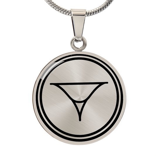 Circular silver pendant engraved with a minimalist geometric symbol, photographed on a white background.