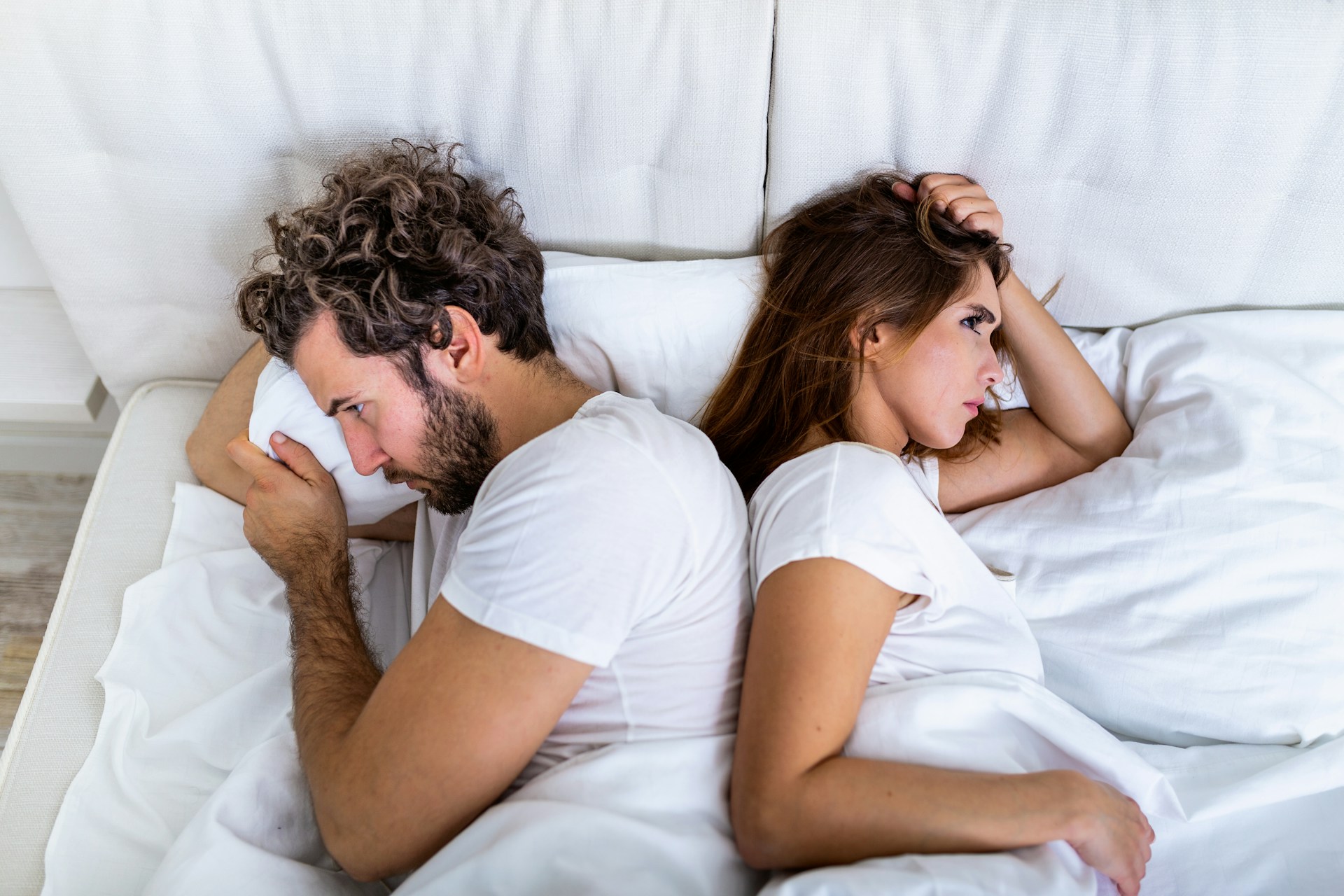 Couple sitting together while experiencing emotional distance and a loss of sexual desire